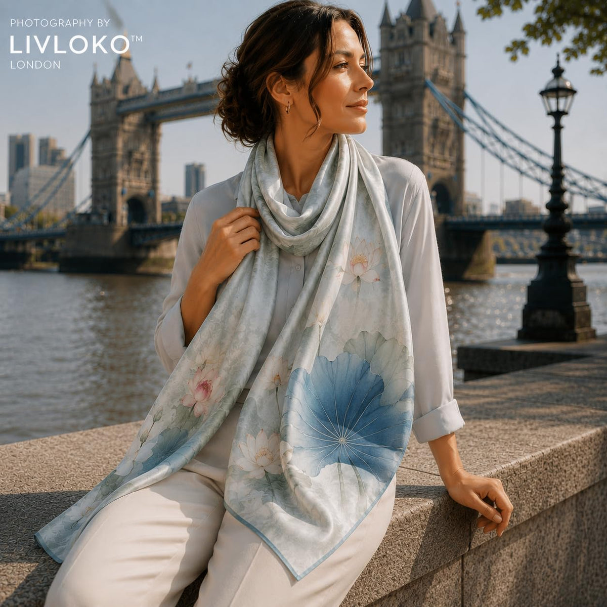 Woman wearing Blue Lotus floral 100% mulberry silk scarf, LIVLOKO LONDON