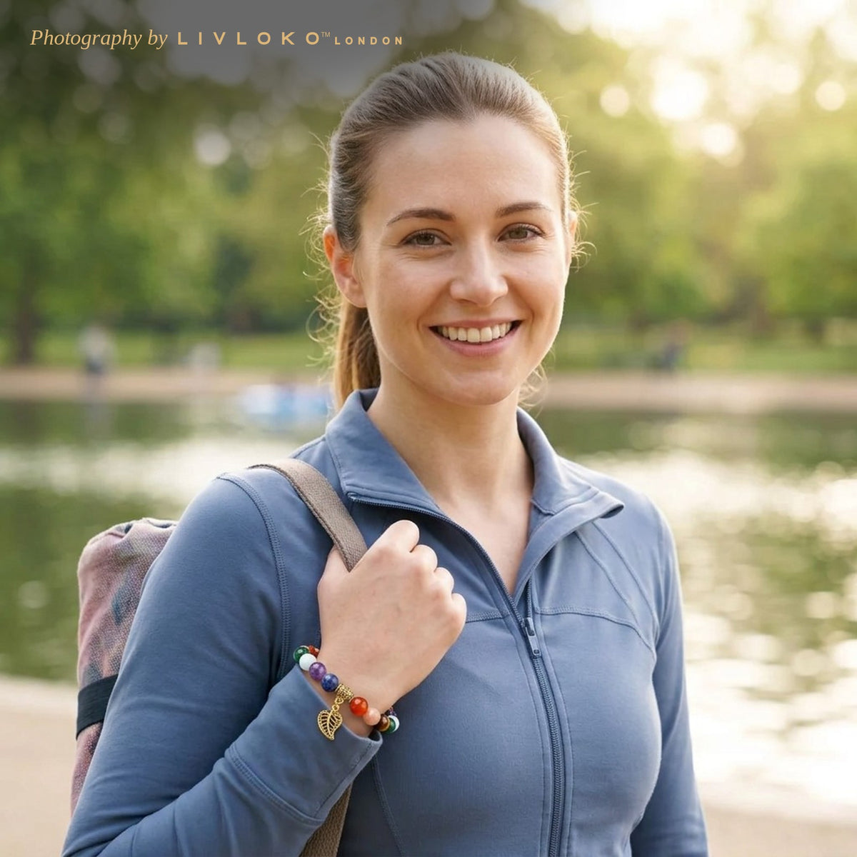 Woman wearing the Livloko London 7 chakra bracelet with leaf charm on her way to yoga in Hyde Park, London