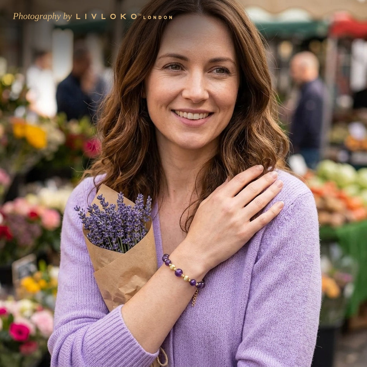 Woman wearing the Livloko London amethyst crystal bracelet with gold plated clasp at a London flower market