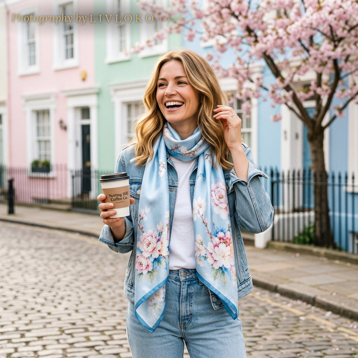 Woman wearing the Floral Blossom light blue mulberry silk scarf in Notting Hill, London, LIVLOKO LONDON