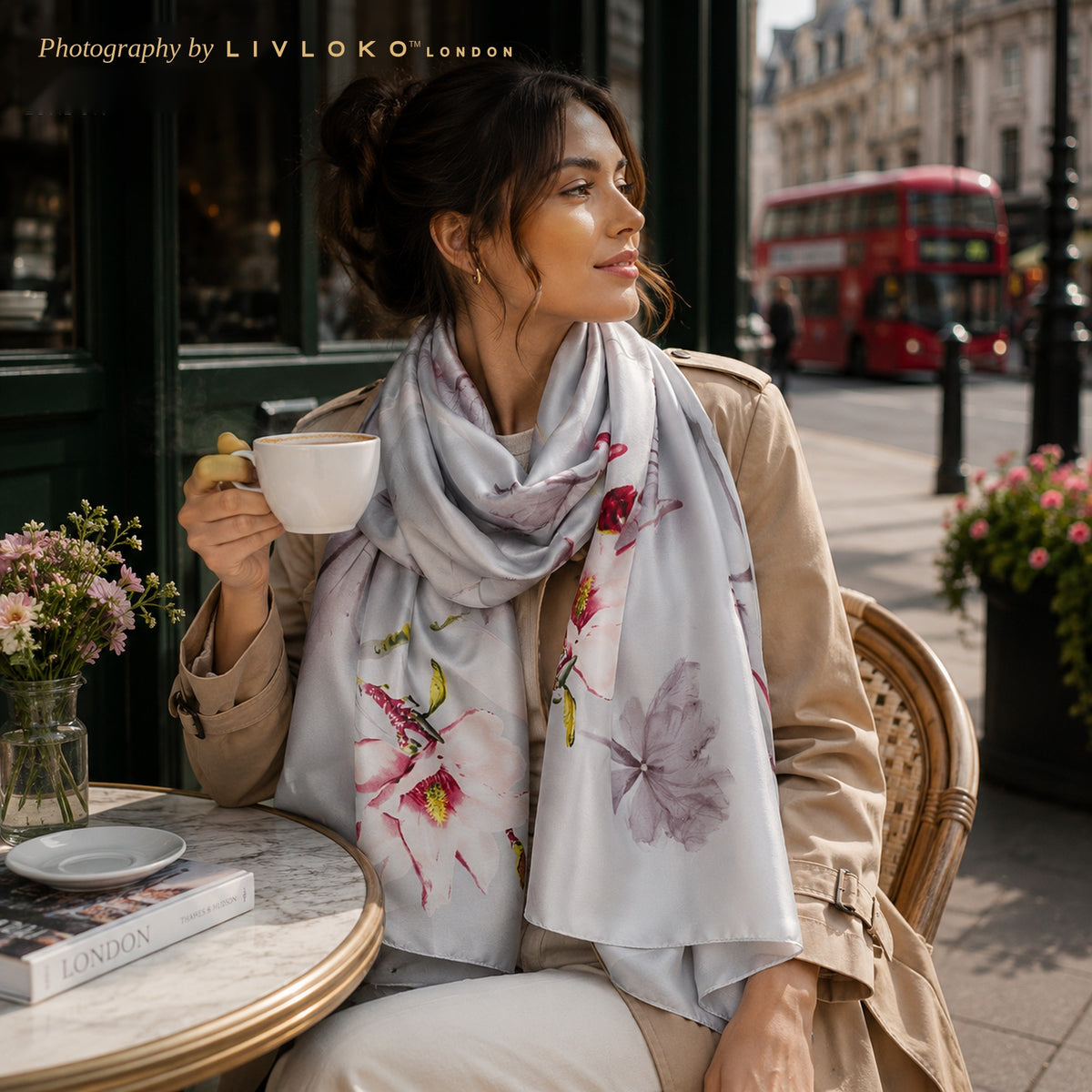Woman wearing the silver floral satin scarf as a long neck scarf at a London cafe