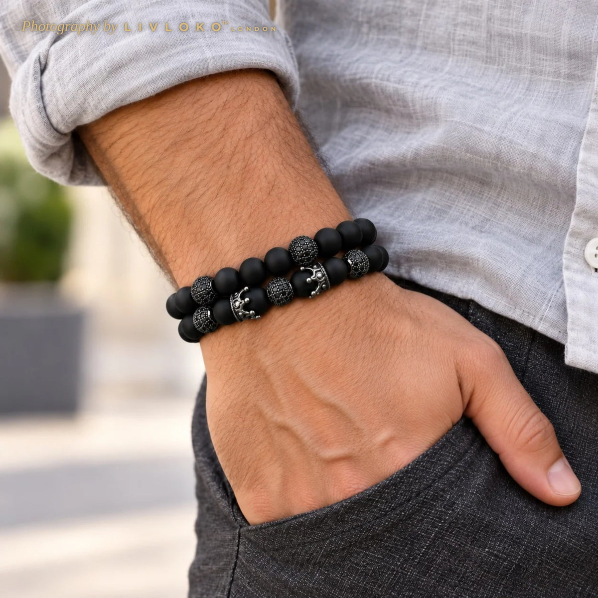Men's black agate crown bracelet set worn on the wrist with a grey linen shirt