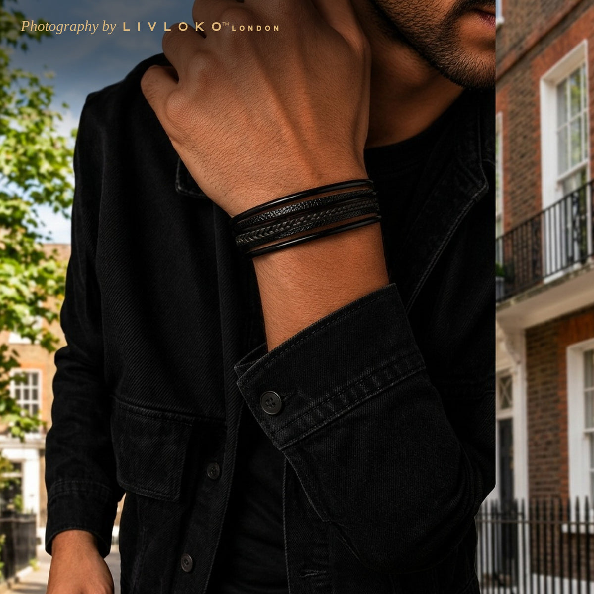 Man wearing the men's black braided leather bracelet with a black jacket on a London street