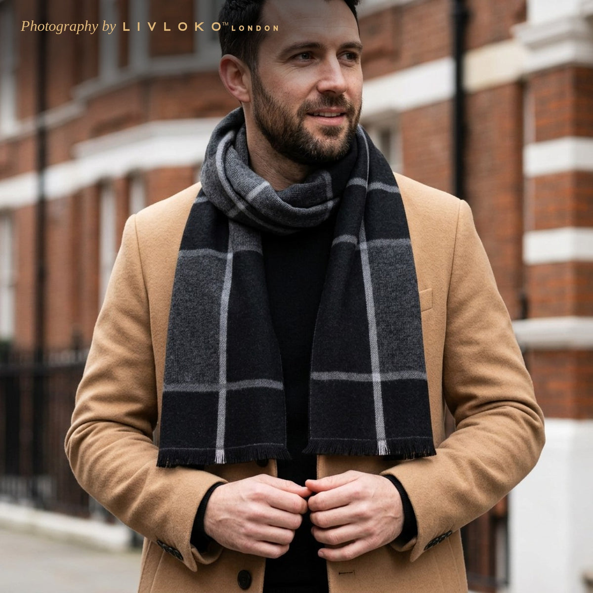 Man wearing the Livloko London men's black and grey checked wool scarf with a camel coat in London