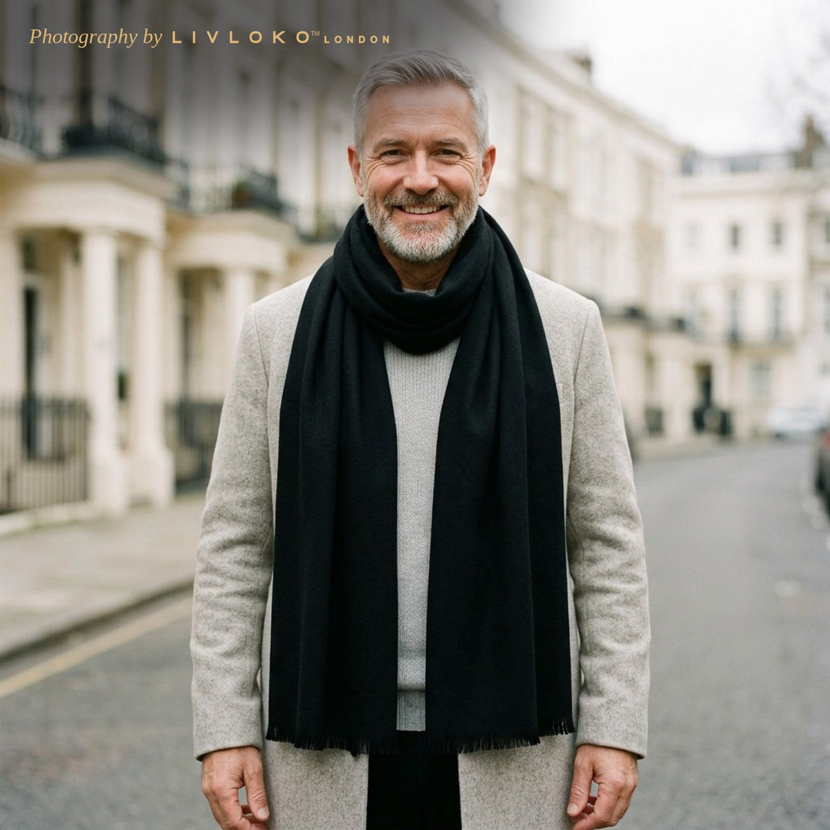Man wearing the LIVLOKO London deep black wool scarf with a light grey overcoat