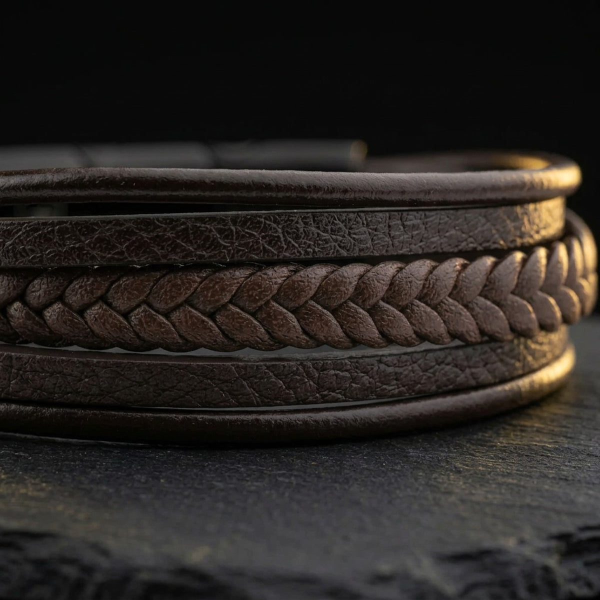 Close-up of the braided and smooth genuine leather strands on the men's brown leather bracelet