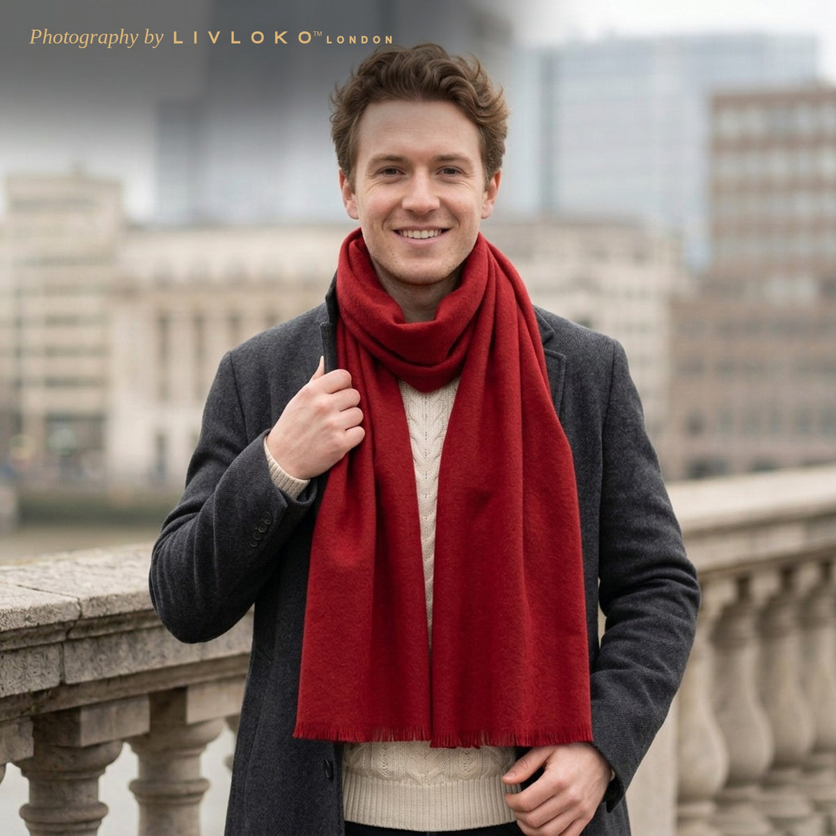 Man wearing the Livloko London men's deep red wool scarf with a grey overcoat on a London bridge