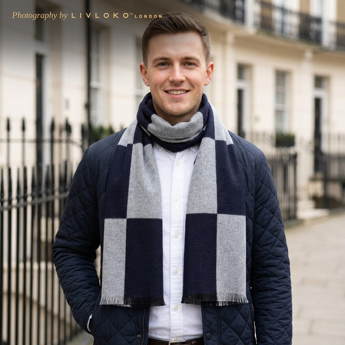 Man wearing the Livloko London men's navy and grey check wool scarf with a navy jacket in London