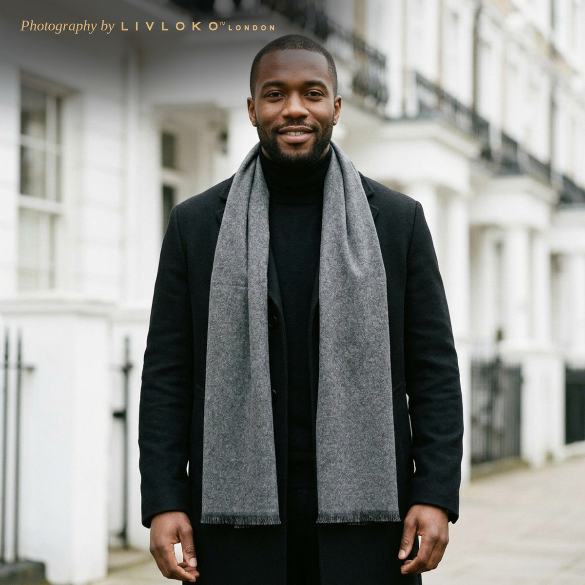 Man wearing the Livloko London men's plain grey wool scarf with a black overcoat in London