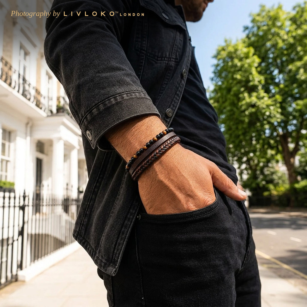 Man wearing the men's tiger eye and agate braided leather bracelet with a black denim jacket in London