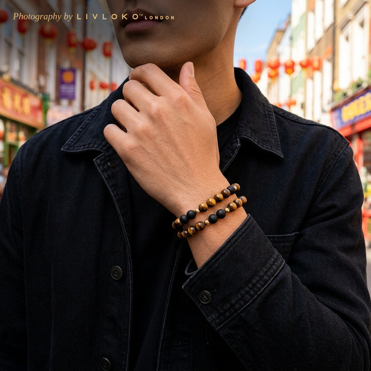 Man wearing the stackable men's tiger eye bracelet set on his wrist in London