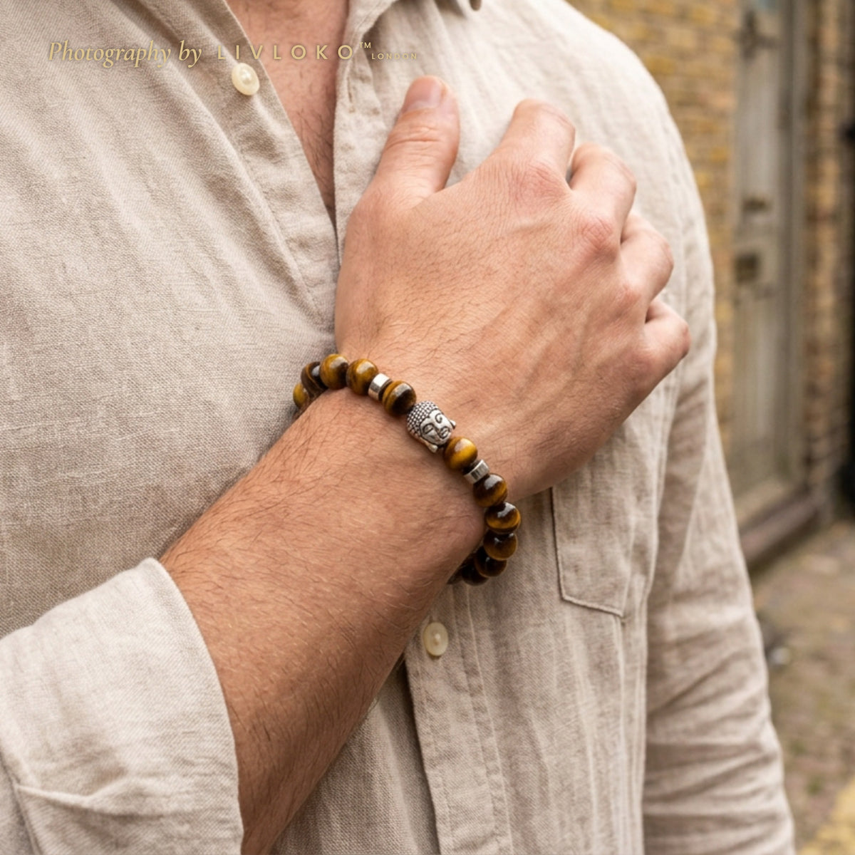 Men's tiger eye beaded bracelet with silver Buddha charm worn on the wrist