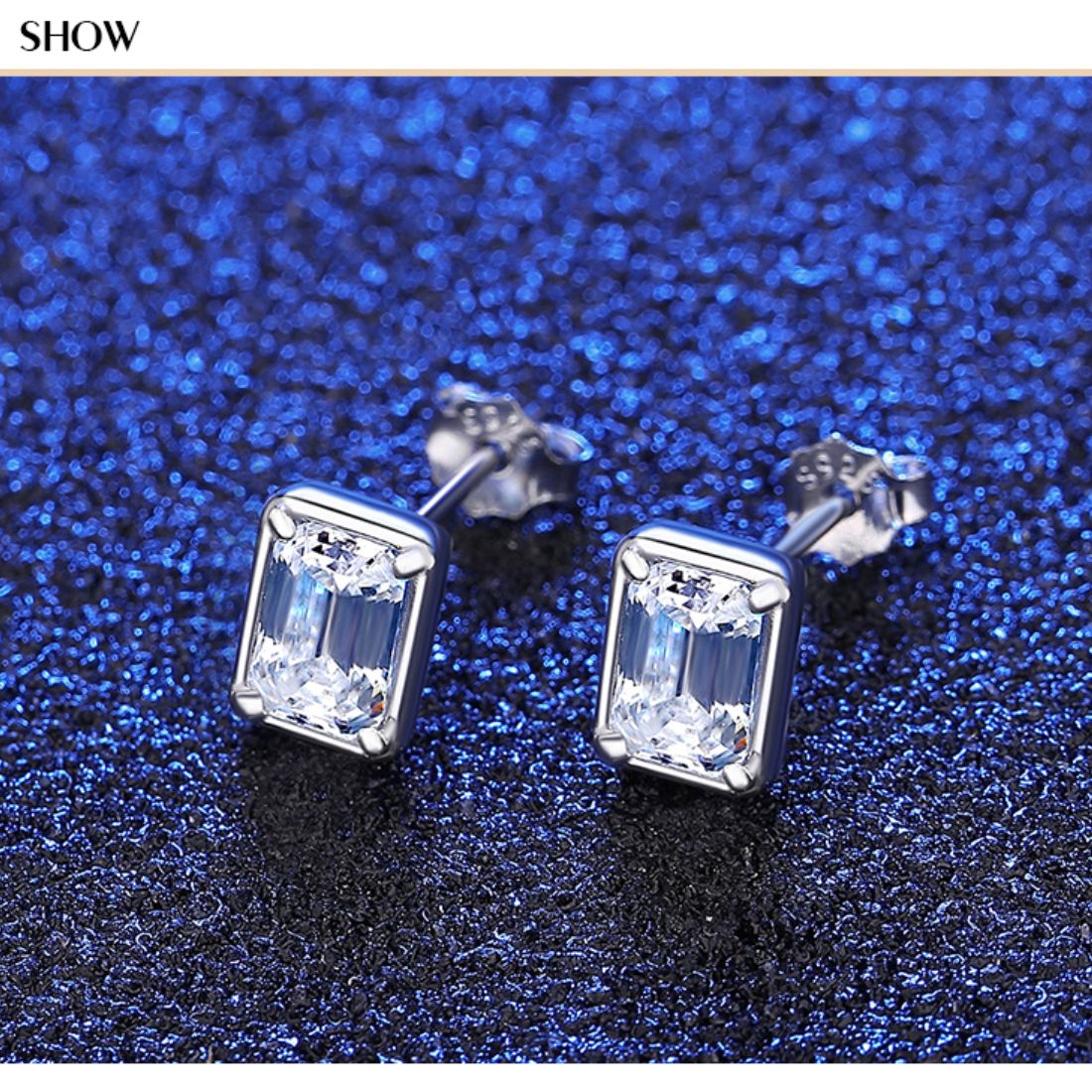 Pair of rectangular clear stone stud earrings sparkling on a deep blue glitter background