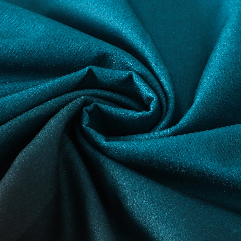 Close-up of the soft fabric swirled together, teal blue shading into black