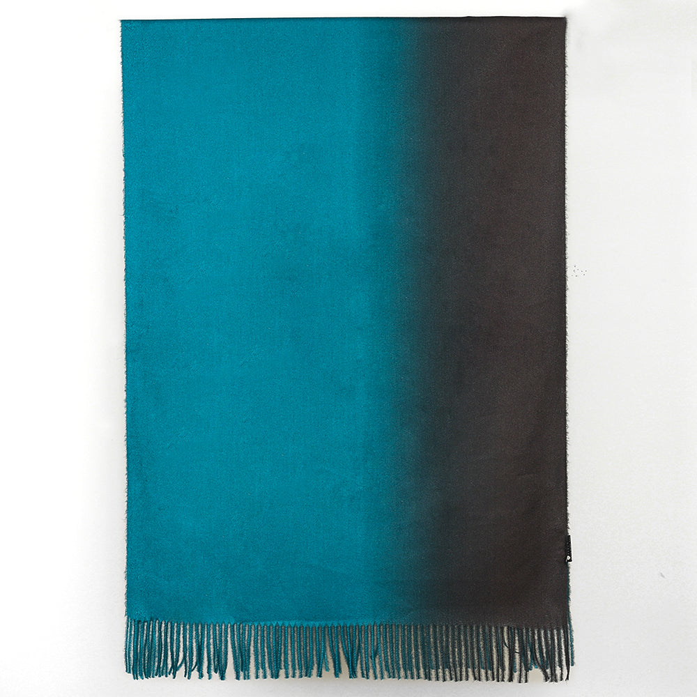 Shawl hung flat showing the gradient from teal blue on the left to black on the right, with fringed hem
