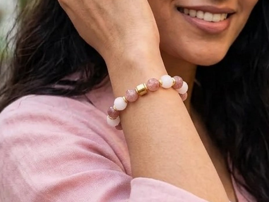 Woman wearing a LIVLOKO London rose quartz bead bracelet