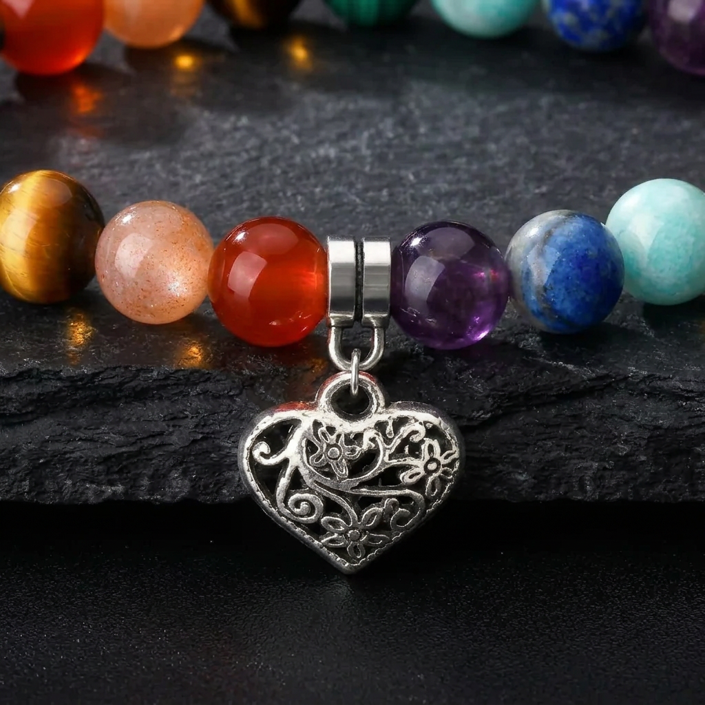 Close-up of the filigree heart charm and chakra colour beads on the Livloko London bracelet