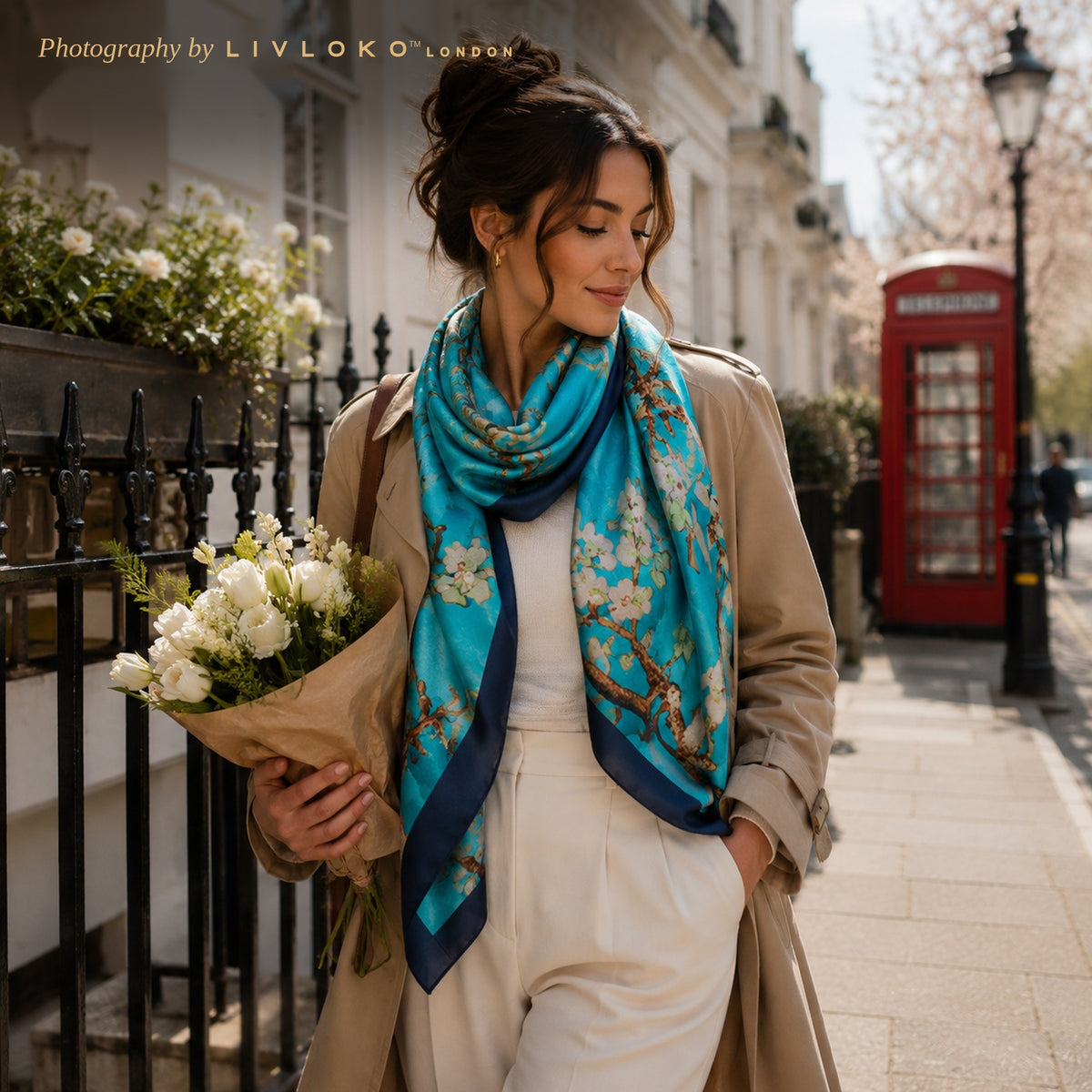 Woman wearing the Almond Blossom light blue satin scarf as a neck scarf on a London street