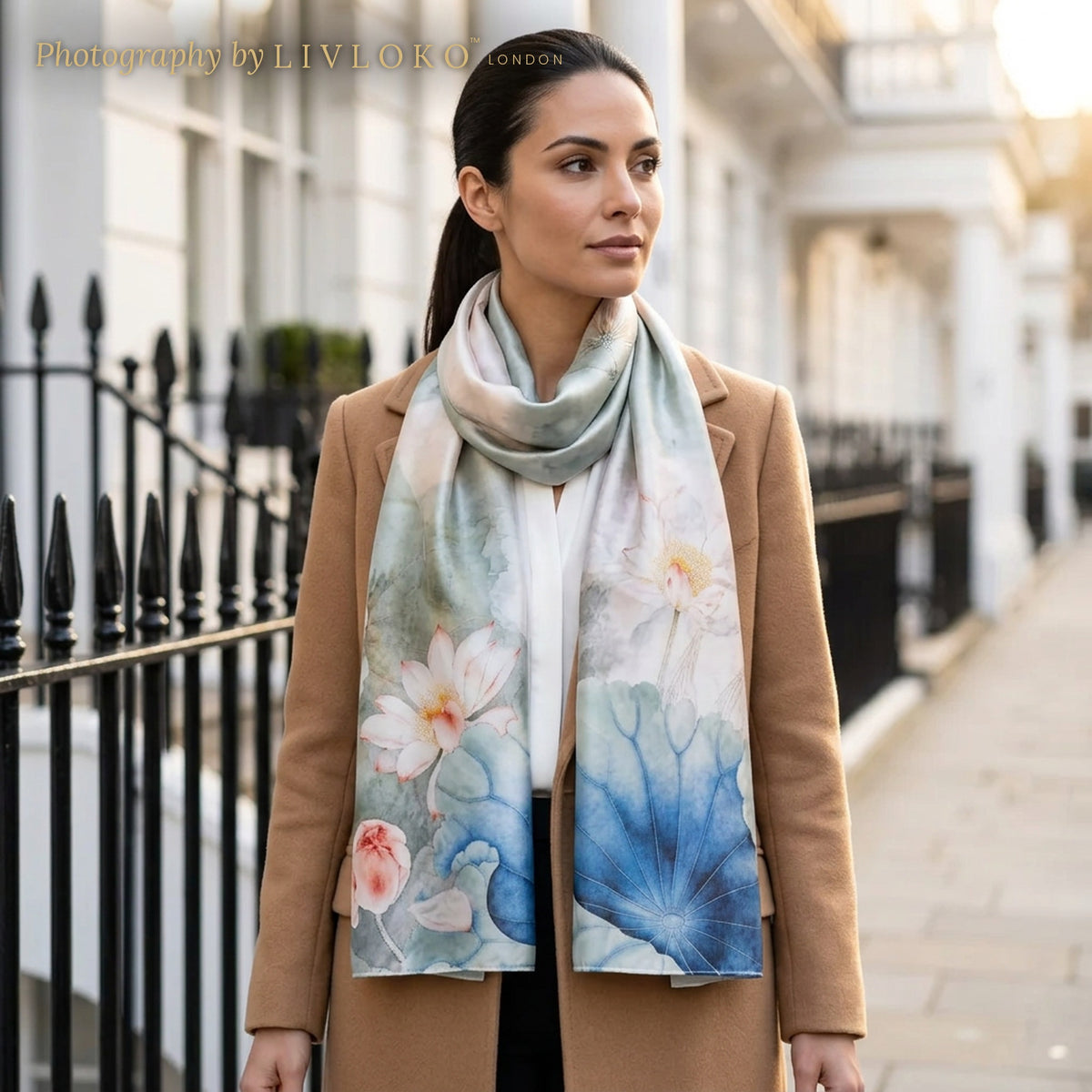 Woman wearing the Blue Lotus blue and white floral silk scarf wrapped around the neck on a London street