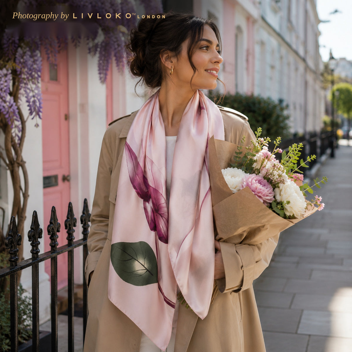 Woman wearing the Oriental Rose pink floral satin scarf at the neck on a London street