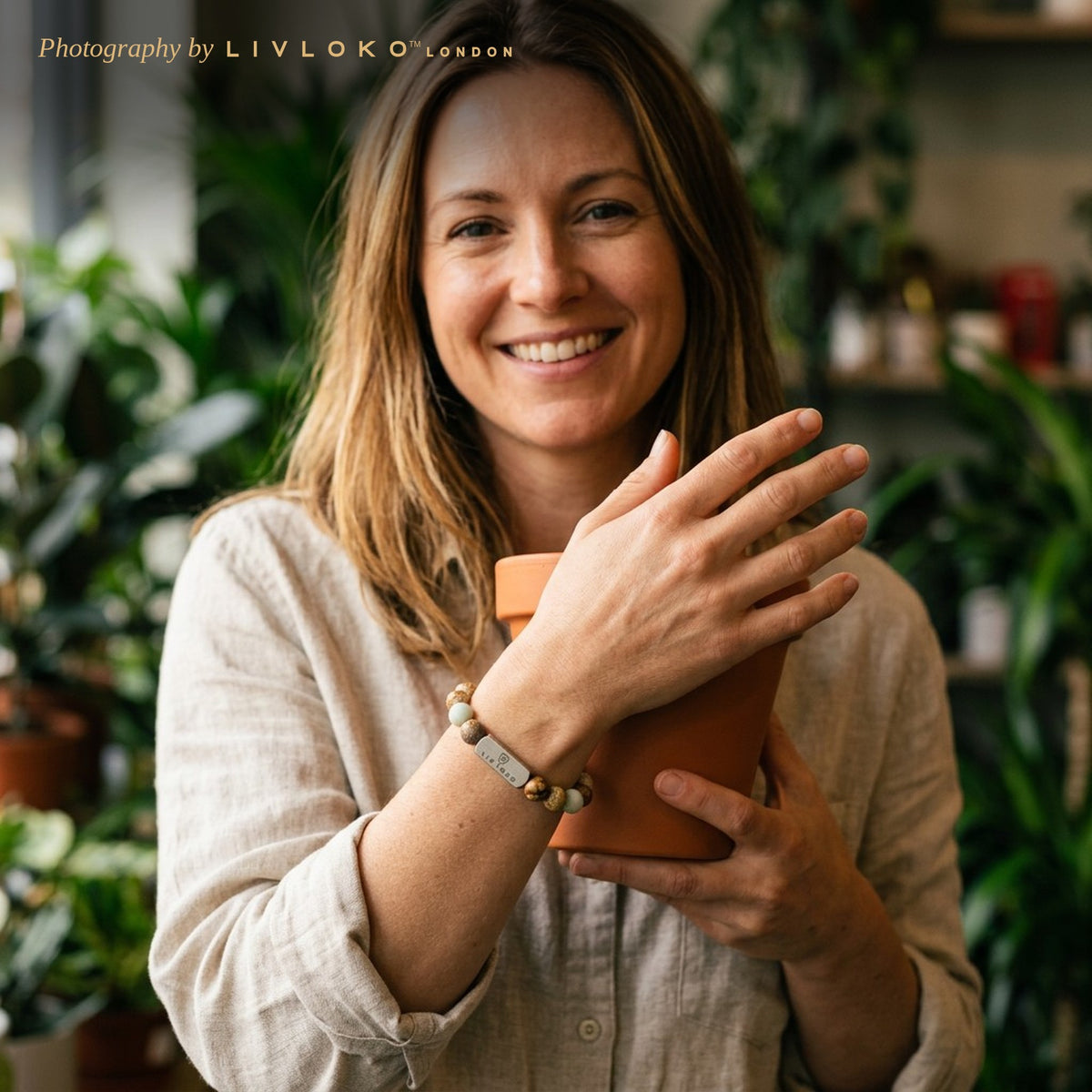 Woman wearing the Livloko London jasper and amazonite stone bead bracelet in a London plant shop