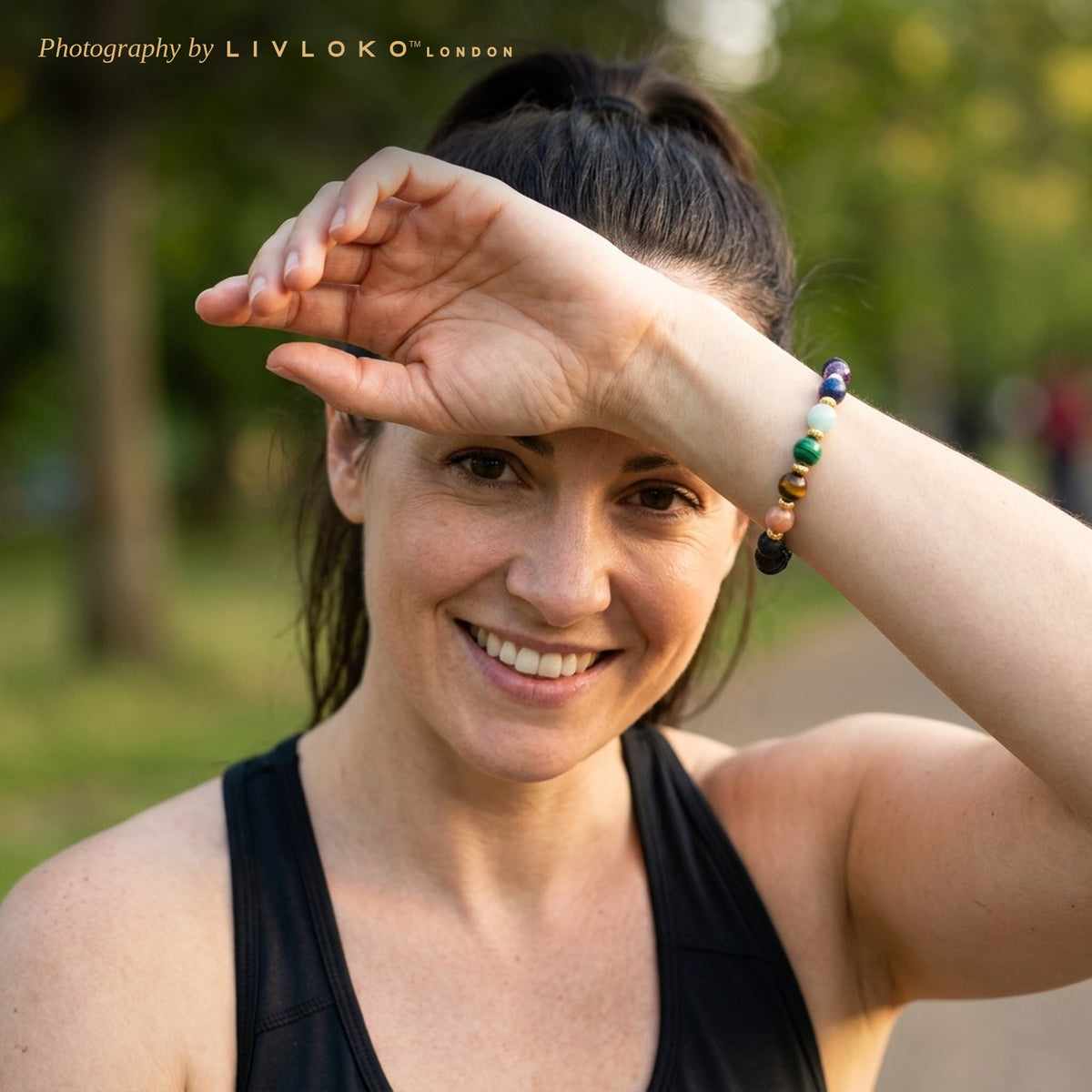 Woman wearing the Livloko London lava stone chakra bracelet after a run in a London park