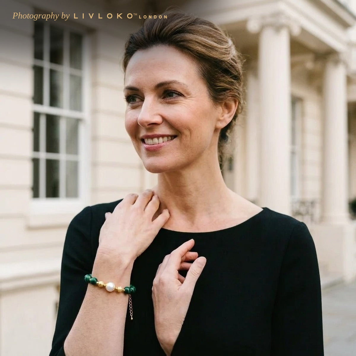Woman wearing the Livloko London malachite and freshwater pearl bracelet outside a London townhouse