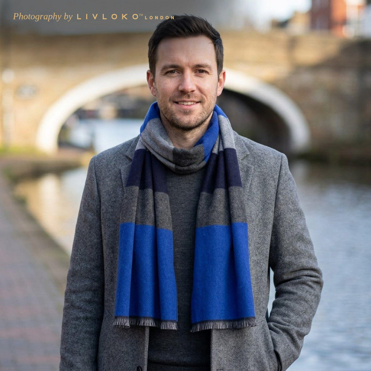 Man wearing the LIVLOKO London blue striped wool scarf with a grey overcoat