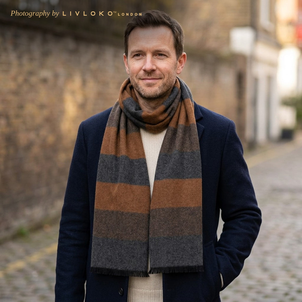 Man wearing the LIVLOKO London grey and brown striped wool scarf with a navy overcoat