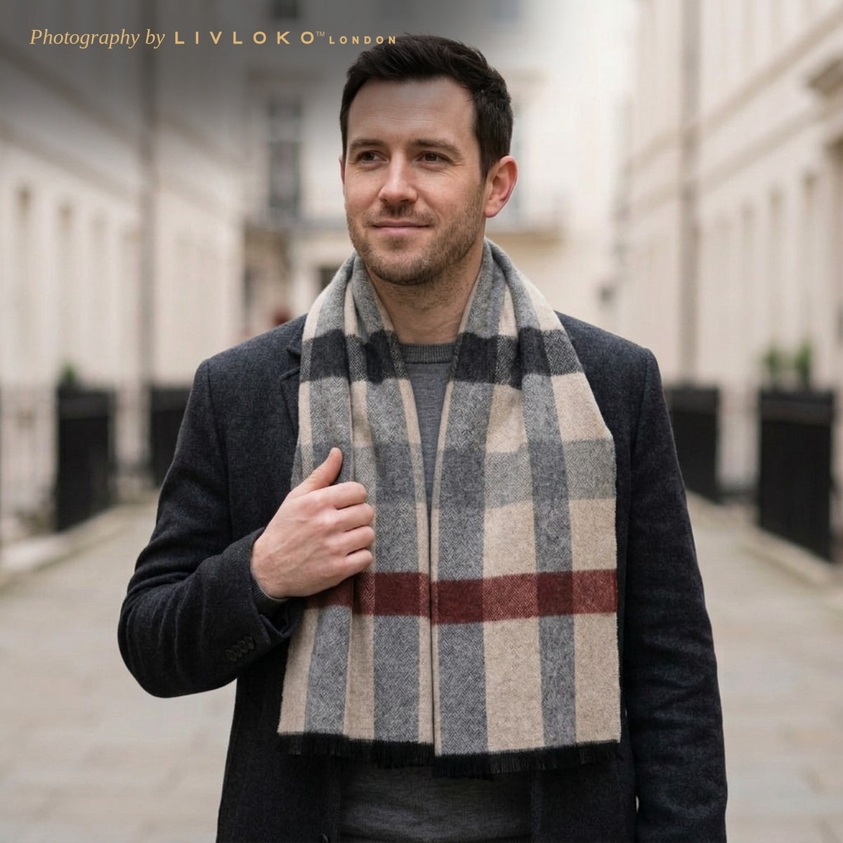 Man wearing the Livloko London men's grey and red check wool scarf with a charcoal coat in London