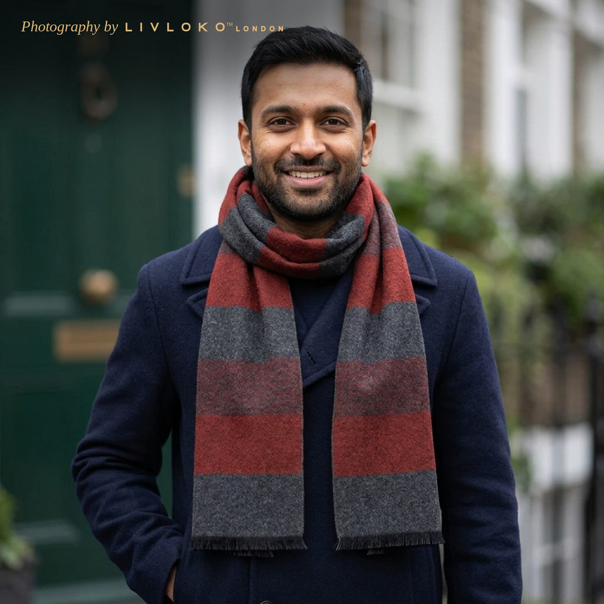 Man wearing the Livloko London men's red and grey striped wool scarf with a navy coat in London