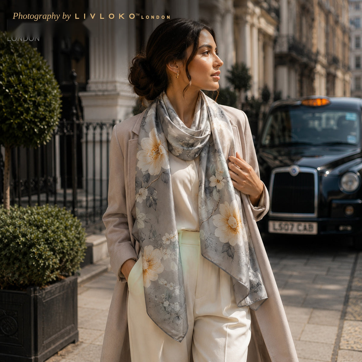 Woman wearing the Midnight Blossom grey floral mulberry silk scarf on a London street