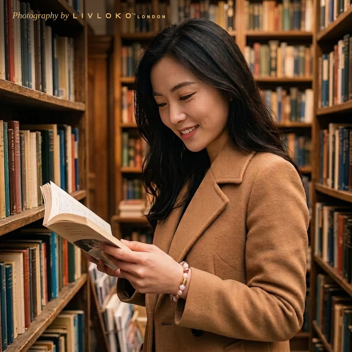 Woman wearing the Livloko London onyx and moonstone crystal bracelet while reading in a London library
