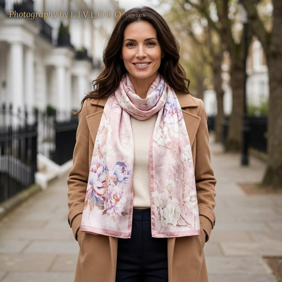 Woman wearing the Rose Garden pink floral silk scarf wrapped around the neck on a London street