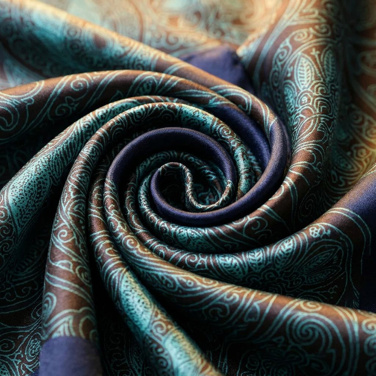 Close-up of the paisley satin scarf swirled to show the detailed paisley-style pattern
