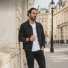 LIVLOKO LONDON men's black braided leather bracelet worn by a man in London, close-up