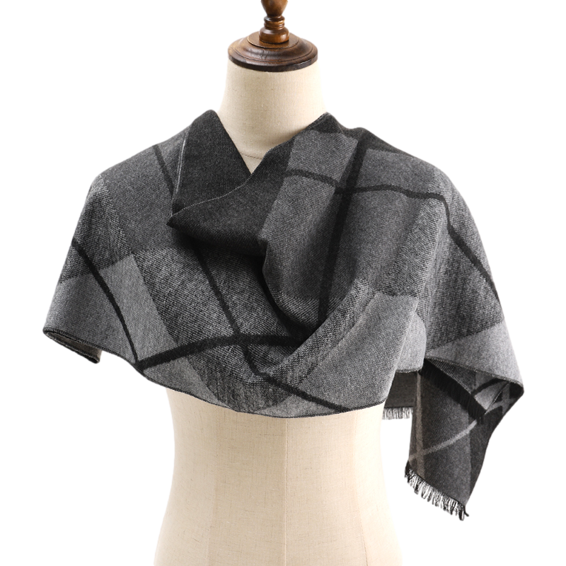 Grey diamond check scarf draped across the shoulders of a mannequin like a wrap