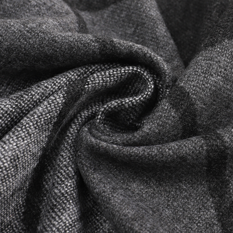 Close-up of grey and charcoal woven scarf fabric gathered in soft folds with dark check lines