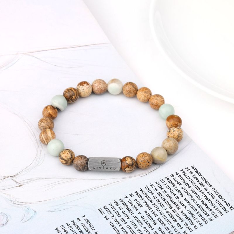 Jasper and Amazonite Bracelet on woman's wrist placed on paper