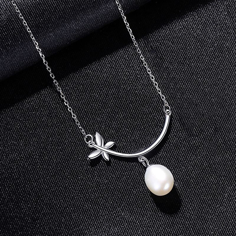 a beautiful unique designed S925 Sterling Silver Natural Pearl Necklace placed on black cloth