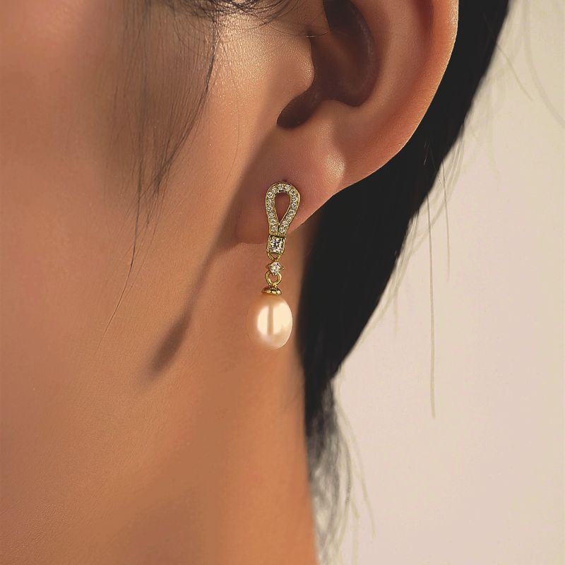 Model wearing Sterling Silver Teardrop Pearl Drop Earrings