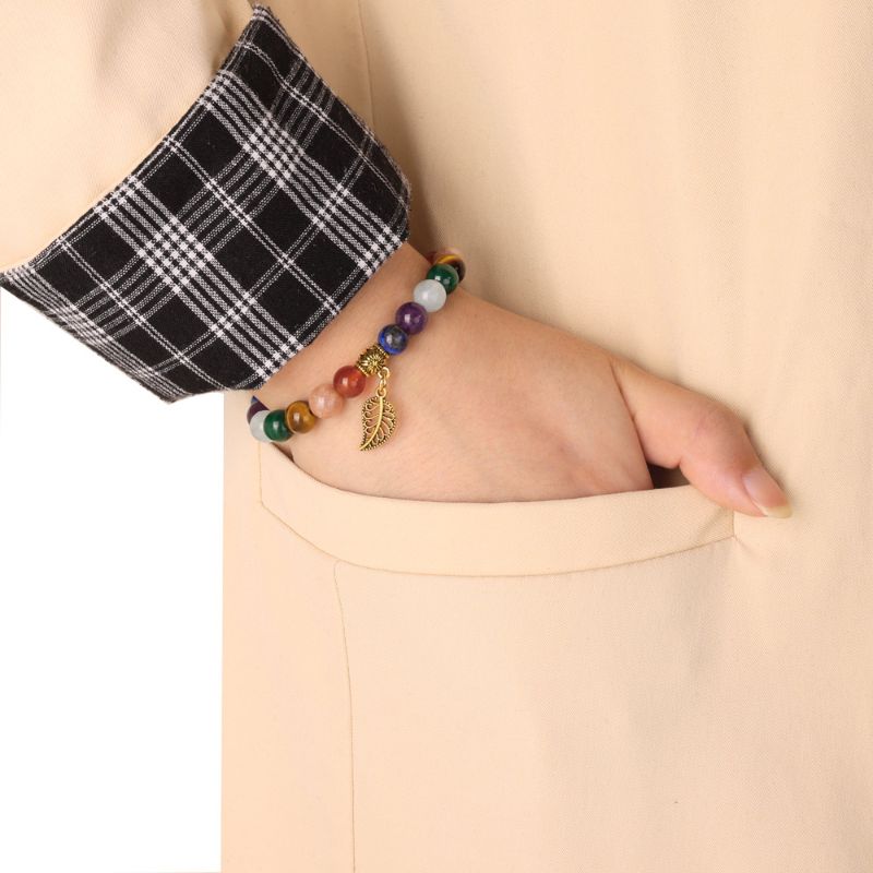 7 Chakra Bracelet & Leaf Pendant around woman's wrist