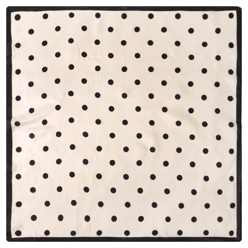 Square scarf laid flat showing evenly spaced black dots on ivory with a narrow black border